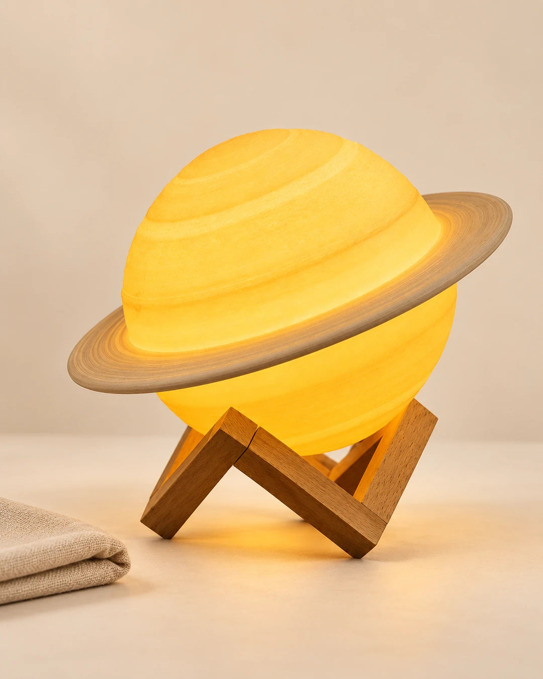 Tosena ringed planet lamp on a bedside surface