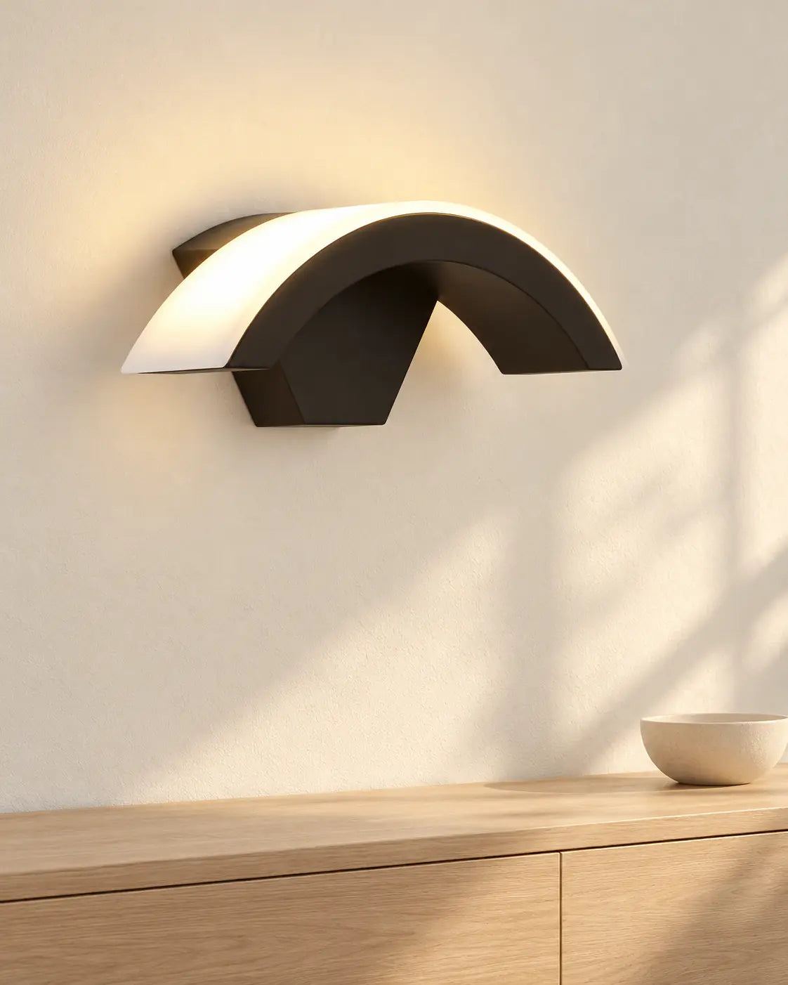 Lunara black arc wall light above a sideboard