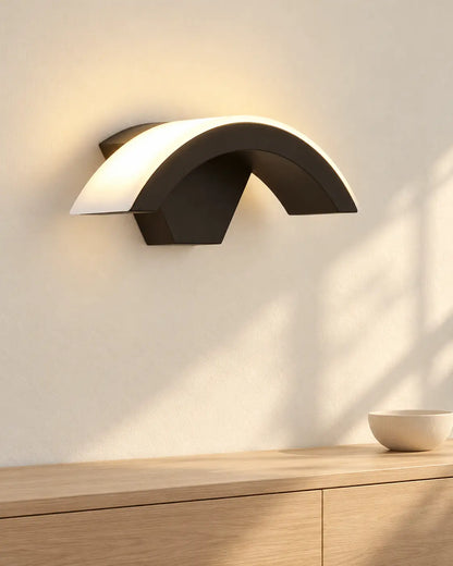 Lunara black arc wall light above a sideboard